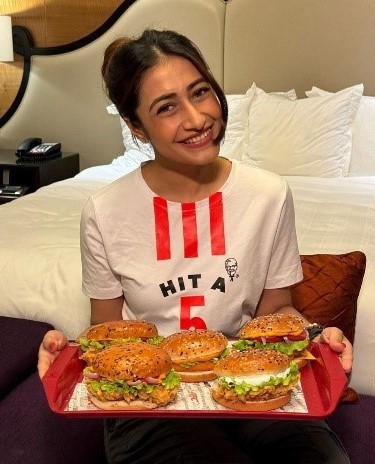 What is the secret of 'Hit A5' written on Dhanashree's T-shirt?